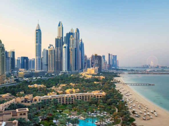 Aerial view of Jumeirah area with luxury beachfront, modern skyscrapers, and lush gardens in Dubai, showcasing Jumeirah Garden plots for sale near the coast.