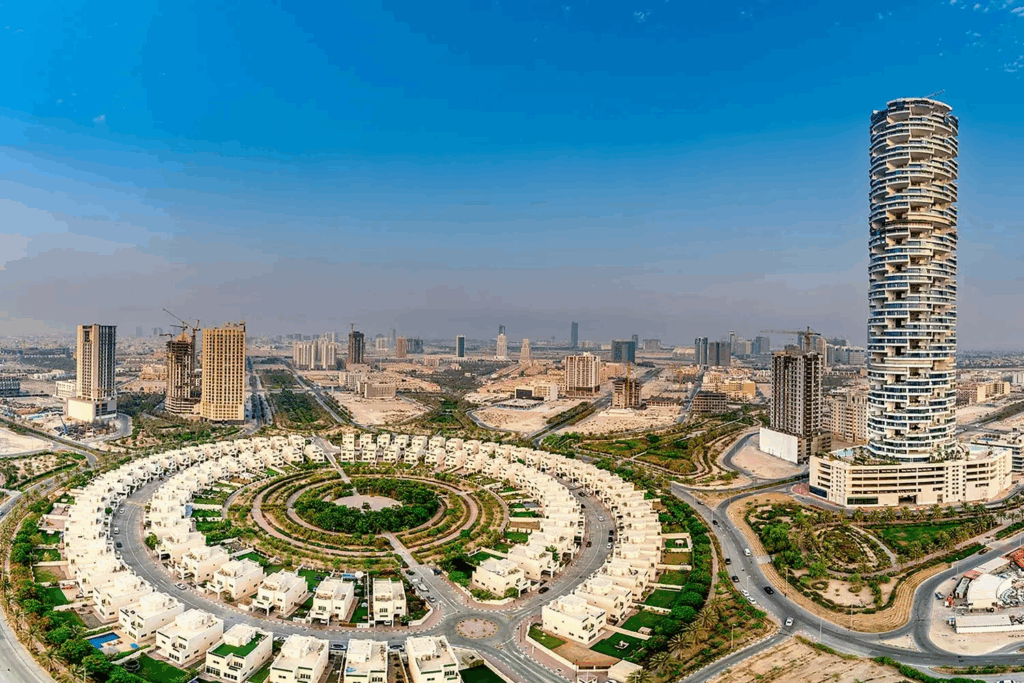Panoramic view of modern residential buildings and circular villas in Jumeirah Village Circle — ideal area to buy land downtown Dubai.